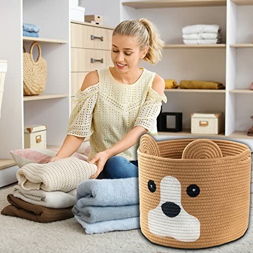 Woman folding laundry next to a cute animal-themed basket.